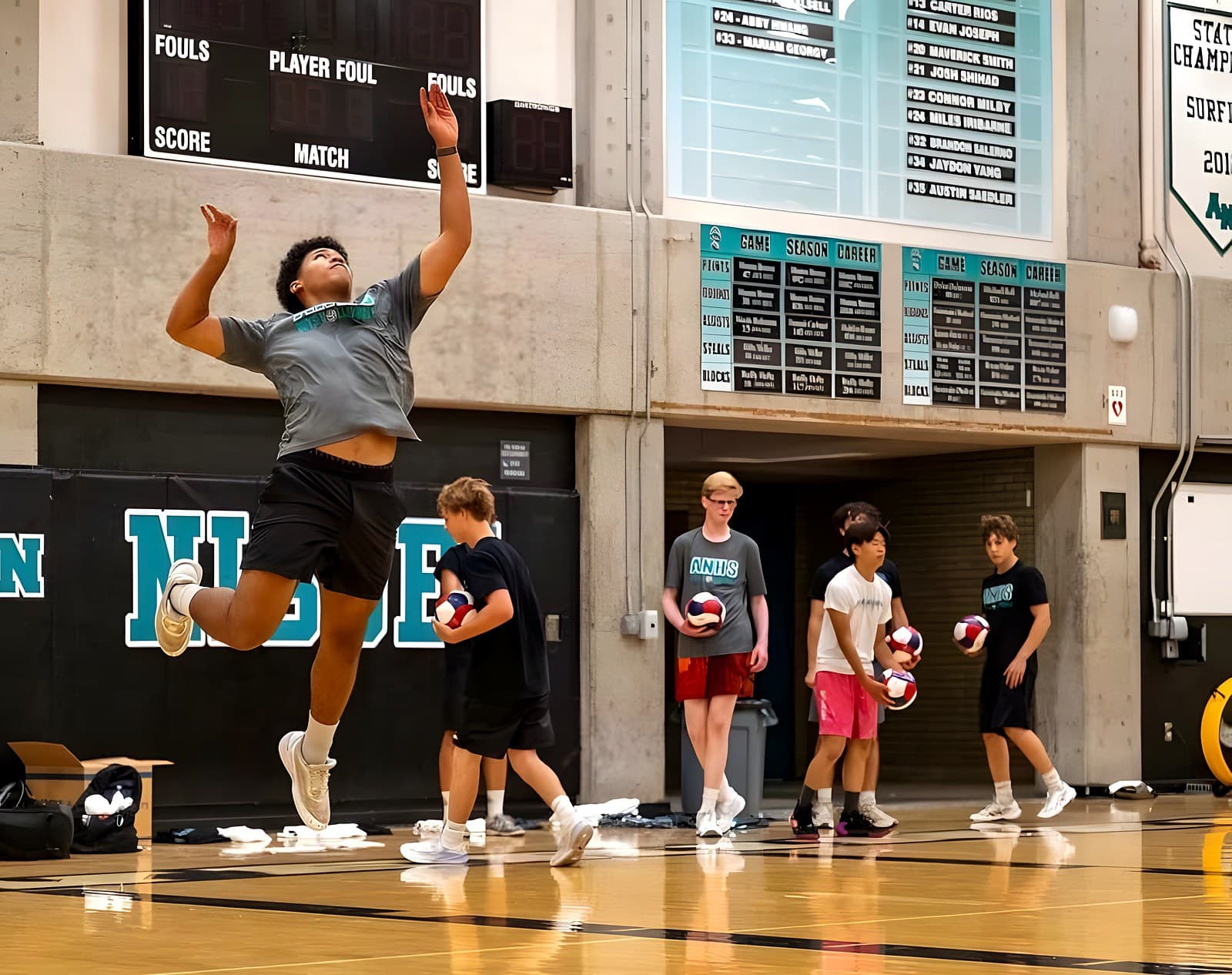 A player serves during Coach Dixon's summer camp in the ANHS gym