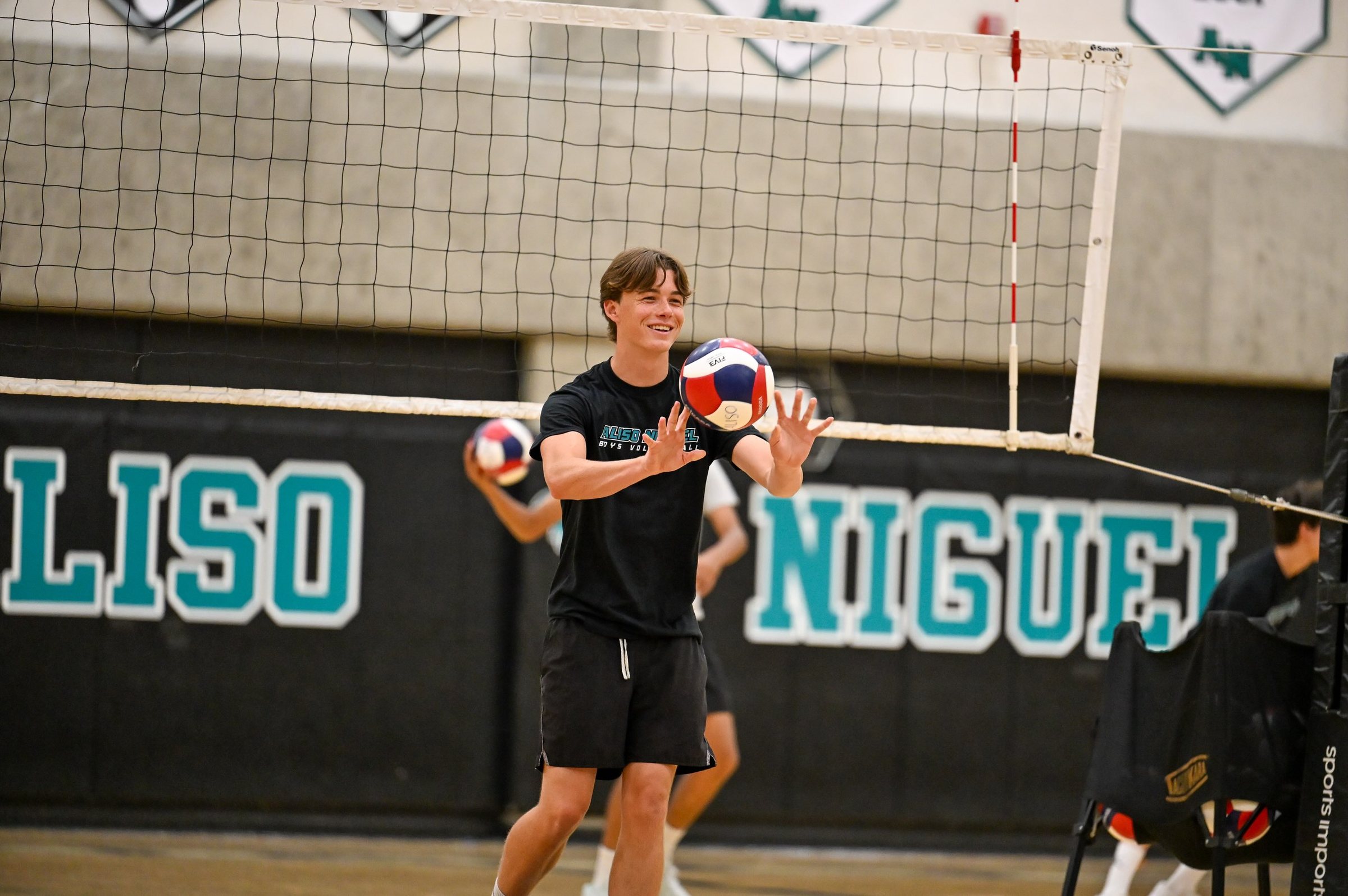 A player sets the ball in front of the Aliso Niguel wall