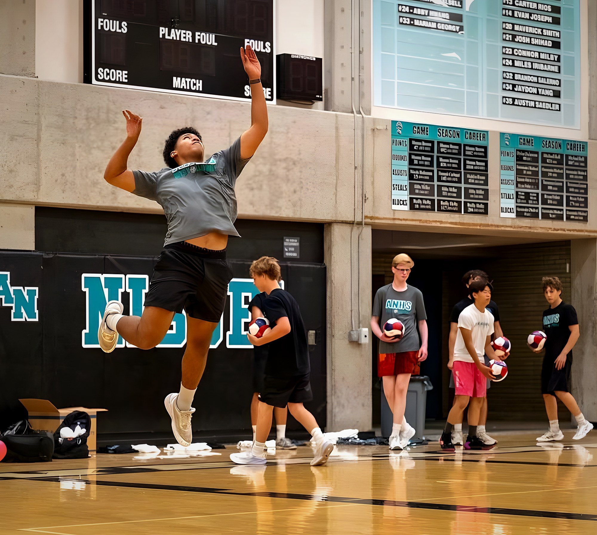A Wolverine player hangs in the air mid jump serve in front of the Aliso Niguel wall in the ANHS gym